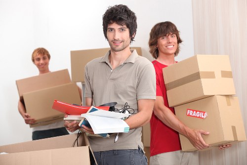 Packed moving boxes and wrapped furniture ready for a Bayswater home move