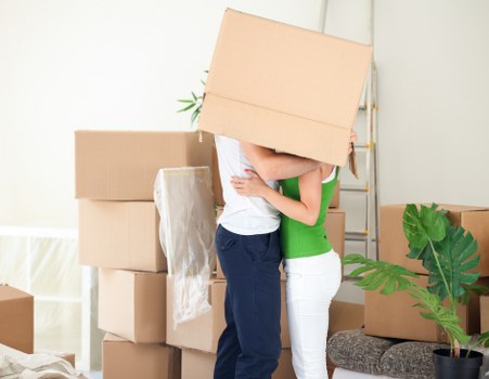 Worker assessing lifting risks before moving furniture